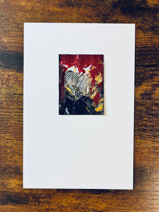 Original artwork by Anet Skillin. This miniature abstract painting is painted on Kraft paper, in black, white, red, and yellow ochre colors; mounted on 4x6-inch paper and photographed against a wooden table.