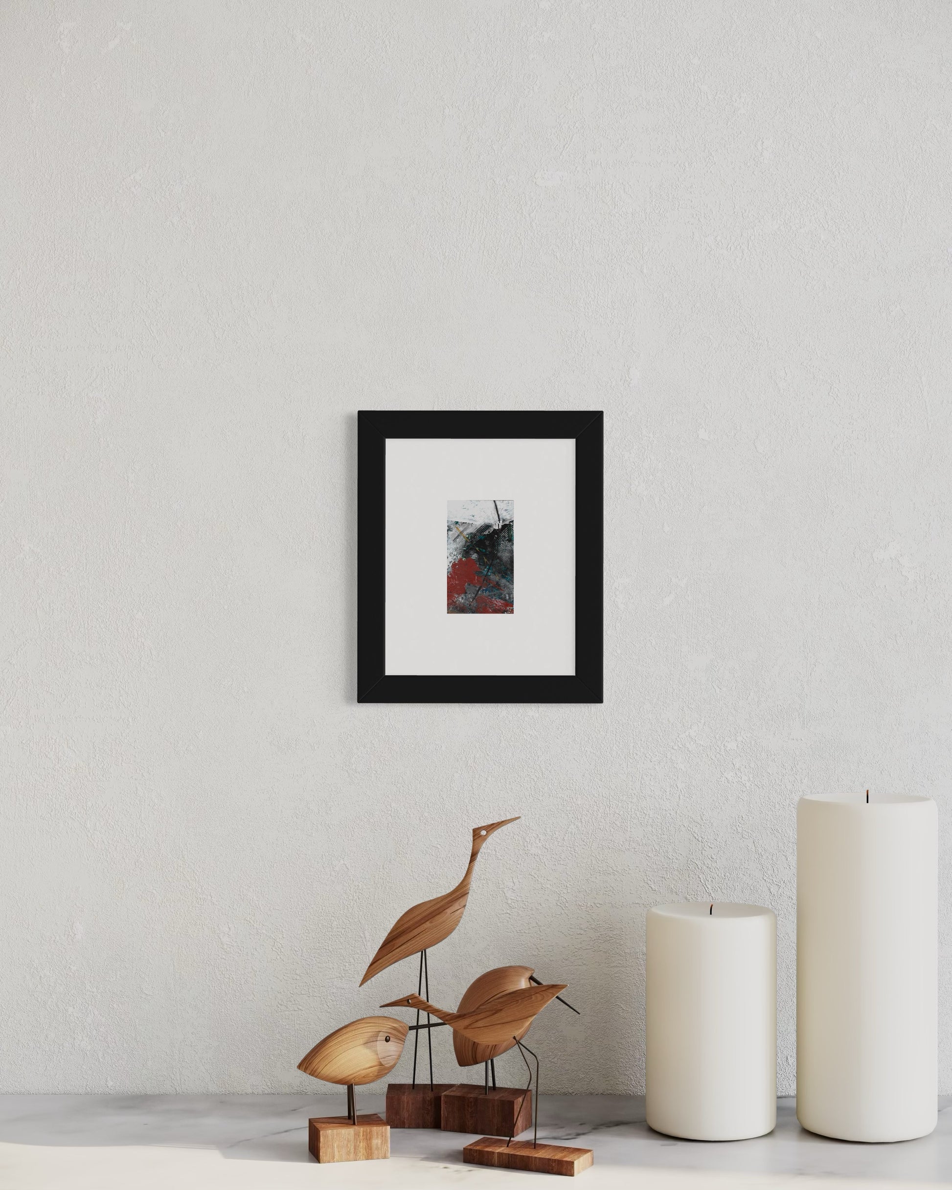 Original artwork by Anet Skillin. This miniature abstract is painted on recycled packaging in white, red, blue and yellow-ochre colors. Photographed in situ behind a table with candles and carved birds.