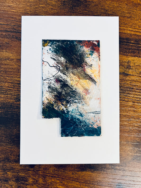 Original rectangular miniature abstract painting with a cut-out lower left corner revealing the mounting stock beneath. Painted in yellow, grey, peach, red, and teal colors of acrylic, ink, oil sticks and mascara on recycled packaging, text from the packaging is faintly visible. Mounted on 4x6-inch watercolor paper in portrait orientation, photographed on a wooden table.